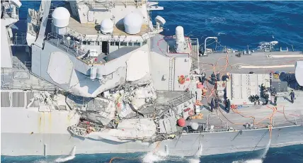  ?? AP ?? The US destroyer was dented and scraped but did not appear to have suffered any major structural damage.