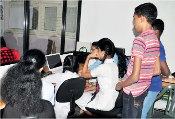  ??  ?? English with a difference: The children get ready for their twice weekly chat . Pix by Ranjith Perera