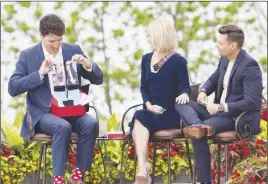  ?? CP PHOTO ?? Prime Minister Justin Trudeau holds up a pair of socks he received as a gift from Kelly Ripa and Ryan Seacrest during his appearance on Live with Kelly and Ryan in Niagara Falls.