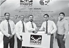  ??  ?? Hasib Omar, CEO, Moose Clothing Company hands over the sponsorshi­p to Saif Yusoof, President, Mercantile Football Associatio­n