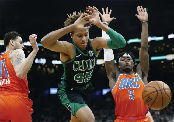  ?? AP ?? DROPPING THE BALL: Celtics guard Romeo Langford loses control of the ball as Oklahoma City Thunder forwards Abdel Nader and Luguentz Dort defend on Sunday.