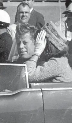  ?? Picture: AP. ?? President John F Kennedy and his wife, Jacqueline, wave to crowds in Dallas moments before the shooting.