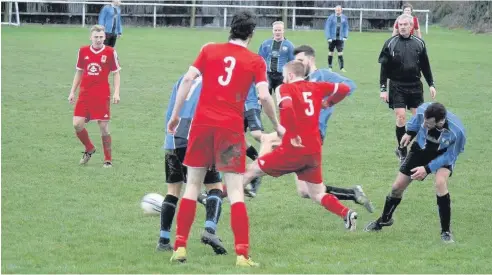  ??  ?? Cemaes Bay (red) take on Trearddur Bay United Reserves at School Lane last Saturday. Picture: EDRYD JONES