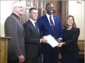  ?? ASSOCIATED PRESS FILE PHOTO ?? Michigan Supreme Court Chief Justice Bridget McCormack and Lt. Gov. Garlin Gilchrist, second from right, present a report on jail and pretrial incarcerat­ion to House Speaker Lee Chatfield, second from left, and Senate Majority Leader Mike Shirkey on Jan. 14, 2020, at the state Capitol in Lansing.