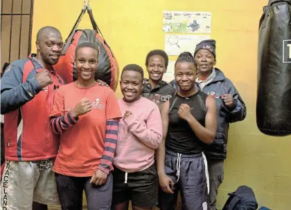  ?? Picture: SUE MACLENNAN ?? CLUB OF CHAMPIONS: Taking a break from training at Mfuzo Boxing Camp in Makhanda on Friday July 15 are, from left, profession­al boxer Lubabalo Bokuva, new SA Youth Champion Esona ‘The General’ Peter, silver medallists Azola ‘Destroyer’ Moses and Luyolo ‘Killer Queen’ Nketsheni, and behind, to the right, are dedicated trainee coach Sindiswa Nyamanda and coach Tyson Dibelo.