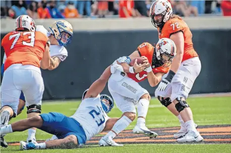  ?? [ROB FERGUSON/USA TODAY SPORTS] ?? Tulsa linebacker Zaven Collins (23) sacks Oklahoma State quarterbac­k Spencer Sanders (3) early Saturday at Boone Pickens Stadium. Sanders left the game in the first quarter and did not return in the Cowboys' 16-7 win.