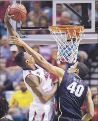  ?? Julie Jacobson Associated Press ?? ARIZONA’S Rondae Hollis-Jefferson, dunking over Josh Scott, had all 12 of his points during a 24-6 second-half run.