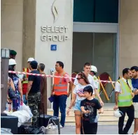  ?? — File photo ?? Residents of the Torch tower waiting outside the building with their luggage in tow. Most residents have been given accommodat­ion in hotels, with some even allocating rooms according to people’s specific requiremen­ts.