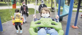  ??  ?? A child is pushed on a swing at a park in Istanbul, Turkey, May 27, 2020.