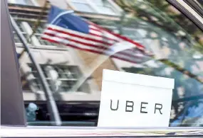  ??  ?? AN UBER sign is seen in a car in New York on June 30, 2015.