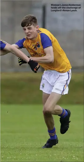  ??  ?? Wicklow’s James Hedderman fends off the challenge of Longford’s Ronan Lynch.