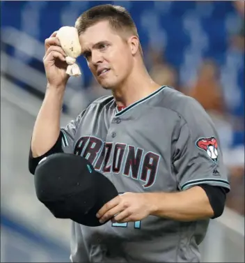  ?? WILFREDO LEE – THE ASSOCIATED PRESS ?? Arizona Diamondbac­ks starting pitcher Zack Greinke, enjoying the Miami weather on a late July night Friday, might find himself sweating out a trade somewhere this week.