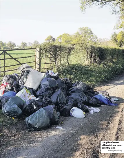  ?? Christophe­r Furlong ?? > A pile of waste offloaded in a quiet country lane