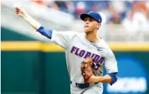  ?? AP PHOTO/NATI HARNI ?? Florida pitcher Jackson Kowar throws against Texas in the fourth inning of Tuesday’s College World Series eliminatio­n game in Omaha, Neb.