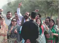  ?? — Reuters ?? Supporters from the ruling PML-N chant slogans outside National Accountabi­lity Bureau court in Islamabad on Monday.