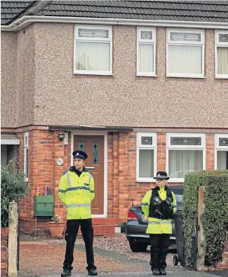  ??  ?? Police officers outside the former minister’s family home in north Wales yesterday