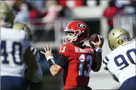  ?? JOHN BAZEMORE — THE ASSOCIATED PRESS ?? Georgia quarterbac­k Stetson Bennett (13) throws a pass in the first half of an NCAA college football game against Charleston Southern, Saturday, Nov. 20, 2021, in Athens, Ga.