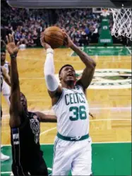  ?? CHARLES KRUPA/AP ?? Boston Celtics guard Marcus Smart (36) drives to the basket past Milwaukee Bucks guard Tony Snell, left, during the first quarter of Game 5 of an NBA basketball first-round playoff series in Boston, Tuesday, April 24, 2018.