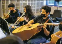  ?? NATHAN BURTON/Taos News ?? Dedrick Rael, 13, right, plays the guitarrón during mariachi band practice with his classmates on Monday (Nov. 8) at Questa Junior/ Senior High School.