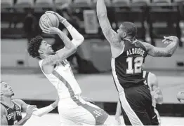  ?? ERIC GAY ?? Rockets center Christian Wood (35) shoots against San Antonio big man LaMarcus Aldridge (12) during the second half of Thursday night’s contest.