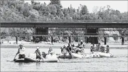  ?? RICH PEDRONCELL­I/AP ?? Rafters hit the cool waters of the American River on May 9 in Rancho Cordova, California.