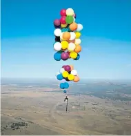  ??  ?? Tom Morgan, of Bristol based The Adventuris­ts, took to the skies near Johannesbu­rg to trial his concept of an air race based on flying in a chair held up with large party balloons.