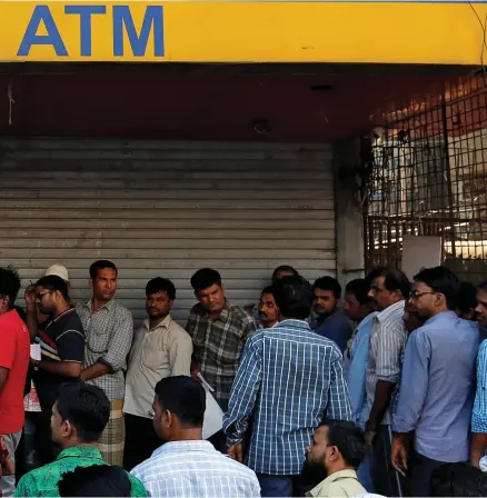  ??  ?? People queue to deposit old banknotes in Mumbai. High value notes were discontinu­ed last year.
Danish Sidiqqui / Reuters