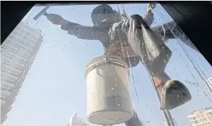  ?? EPA ?? A window cleaner works on a highrise office building in central Bangkok. Thailand’s economy next year is likely to remain sluggish due to global growth remaining subdued, predicts HSBC.