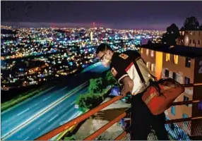  ??  ?? Paramedic Michael Zavala, right, searches a home for a body after receiving an emergency call. No body was found. Tijuana’s mortality rate is twice the national average, and hospitals are low on medical supplies while also facing staffing shortages as health workers fall ill.