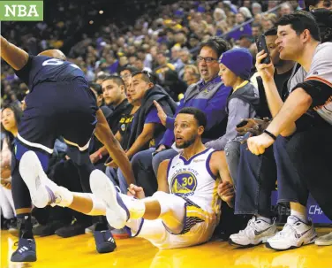  ?? Santiago Mejia / The Chronicle ?? Warriors guard Stephen Curry watches his three-point basket go in against Minnesota Timberwolv­es forward Taj Gibson in the first half at Oracle Arena. Curry and other starters were held to 20 minutes.