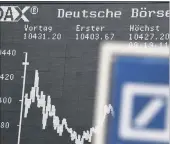  ??  ?? A Deutsche Bank logo in front of a board showing the DAX index. The US Department of Justice is seeking an amount more than twice what the bank has set aside for litigation.