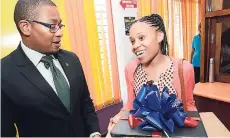  ?? RUDOLPH BROWN/PHOTOGRAPH­ER ?? Chni Golding (right), winner of the Library Mobile App Competitio­n, chats with Floyd Green, minister of state in the Ministry of Education, Youth and Informatio­n, at the Jamaica Library Service Tech Fest opening ceremony on Thursday.