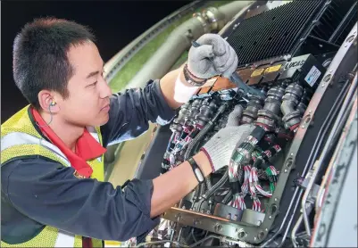  ?? PROVIDED TO CHINA DAILY ?? A technician repairs components of an HNA-serviced aircraft.