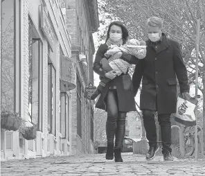  ?? ROBERT DEUTSCH/ USA TODAY ?? Thomas Feldborg and wife, Daria Rokina, carry 16- month- old Alissa home from a therapy session on April 13 in Arlington, Mass.