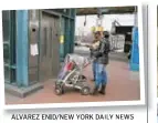  ?? AILY NEWS ?? A woman with a baby carriage checks out the out-of-service elevator at Bronx subway station.