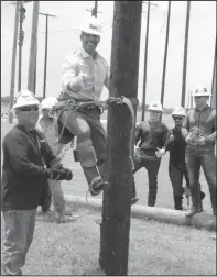  ?? Courtesy photo/ Texas State Technical College ?? Texas Land Commission­er George P. Bush gets a thumbs-up from Electrical Lineworker students after he successful­ly climbs a training pole at Texas State Technical College.