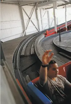  ??  ?? Santa Cruz Beach Boardwalk visitors experience­s thrills and chills while riding the historic Giant Dipper wooden roller coaster.