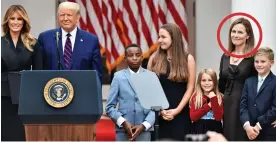  ??  ?? Controvers­ial: Amy Coney Barrett, circled, with four of her children at the White House with Mr Trump and wife Melania