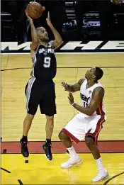  ?? Associated Press ?? San Antonio Spurs guard Tony Parker (9) prepares to shoot over Miami Heat guard Mario Chalmers (15) in the first half in Game 4 of the NBA basketball finals Thursday in Miami.