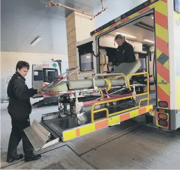  ??  ?? An ambulance crew on standby at Peterborou­gh City Hospital.