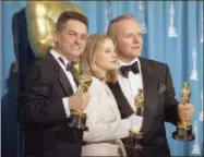  ?? REED SAXON — THE ASSOCIATED PRESS ?? In this file photo, director Jonathan Demme, left, holds his award for best director, actress Jodie Foster holds her award for best actress, and actor Anthony Hopkins holds his award for best actor for their work on “Silence of the Lambs,” at the...