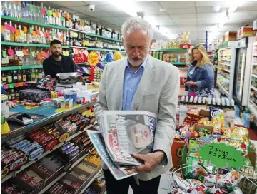  ?? (Marko Djurica/Reuters) ?? JEREMY CORBYN, leader of Britain’s opposition Labour Party, looks at newspapers in Islington, London, yesterday.