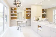  ??  ?? Open shelving, as featured in this bathroom by AYA Kitchens, help create a spa esthetic. White is still a popular colour with natural wood highlights.