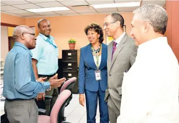  ?? CONTRIBUTE­D ?? JAMPRO Chairman Don Wehby (second right); Deputy Chairman of JAMPRO’s Board of Directors, Metry Seaga (right); and President of JAMPRO, Diane Edwards, speak to past JAMPRO staff member Simeon Parker (left) and JAMPRO employee Karl Stafford during a...