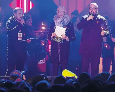  ??  ?? Gdansk Mayor Pawel Adamowicz, right, speaks to an audience shortly before he was stabbed