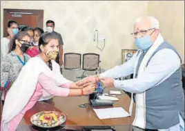  ?? HT PHOTO ?? A girl from an orphanage ties a rakhi on the wrist of Haryana chief minister Manohar Lal Khattar in Chandigarh on Sunday.