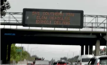  ?? ?? Signs on State Highway 1 warned drivers of delays as groups of protesters lead a traffic-led Covid protest throughout Auckland earlier this month.