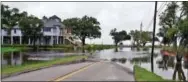  ?? WARREN KULO — THE MISSISSIPP­I PRESS VIA AP ?? Storm surge and heavy rains associated with Tropical Storm Cindy cause flooding in many areas of the Mississipp­i coast, including this area at the foot of Washington Avenue just off Front Beach in Ocean Springs, Miss., Wednesday.