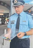  ?? ?? Superinten­dent Peter Miles with knives seized by police at Helensvale Station.