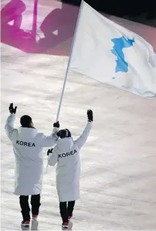  ?? SEAN M. HAFFEY/AFP/GETTY IMAGES ?? United at the Games: Unified Korea’s flag-bearers were South Korean bobsledder Won Yun-jong, left, and North Korean hockey player Hwang Chung Gum.